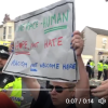 Counter protester, Southport, holding up anti-racism banner.